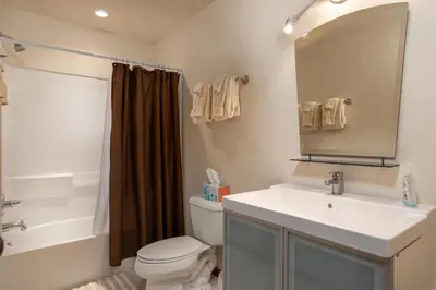 a bathroom with a sink and a toilet and a mirror at Wonderful Mountain Retreat with Fantastic Views in Fraser