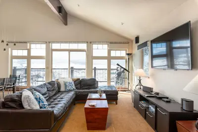 a living room with a couch and a table at Wonderful Mountain Retreat with Fantastic Views in Fraser