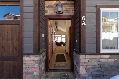 a hallway of a house with a wooden door at Wonderful Mountain Retreat with Fantastic Views in Fraser