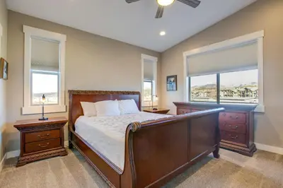 a bedroom with a bed and two windows at 5 Mi to Winter Park Resort Fraser Family Home in Fraser