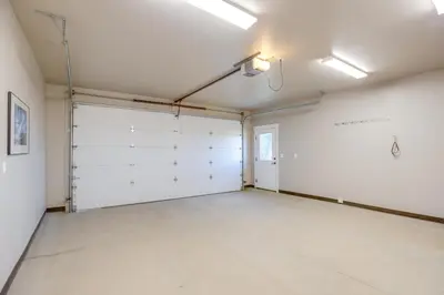 an empty garage with white walls and a door at 5 Mi to Winter Park Resort Fraser Family Home in Fraser