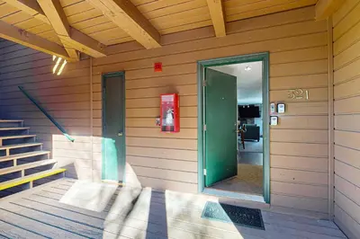 a building with a green door and stairs on it at Mountain View Lakeside Retreat in Dillon