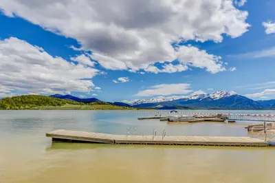 a dock on a lake with mountains in the background at Mountain View Lakeside Retreat in Dillon