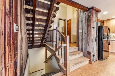 a staircase in a house with wooden walls at Dillon Retreat with Lake Views and Private Hot Tub in Dillon