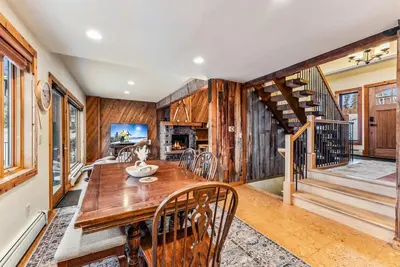 a dining room with a wooden table and a staircase at Dillon Retreat with Lake Views and Private Hot Tub in Dillon