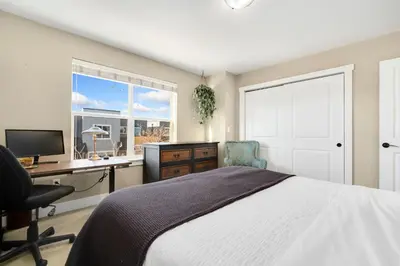 a bedroom with a bed and a desk and a window at Old Town Escape with King Bed, Dog-Friendly in Fort Collins