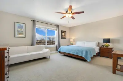 a bedroom with a bed and a ceiling fan at Old Town Escape with King Bed, Dog-Friendly in Fort Collins
