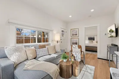 a living room with a couch and a table at Chic Luxury Retreat in Old Town, Walk Everywhere! in Fort Collins