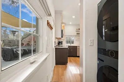 a kitchen with a large window and a microwave at Chic Luxury Retreat in Old Town, Walk Everywhere! in Fort Collins
