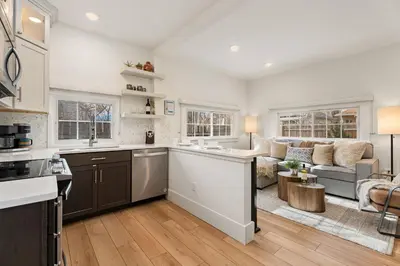 a kitchen and living room with a couch at Chic Luxury Retreat in Old Town, Walk Everywhere! in Fort Collins