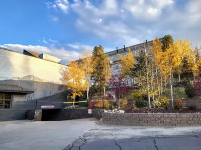 a building with fall trees in front of it at Best Location in Downtown Winter Park in Winter Park