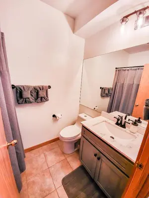 a bathroom with a toilet and a sink at Best Location in Downtown Winter Park in Winter Park