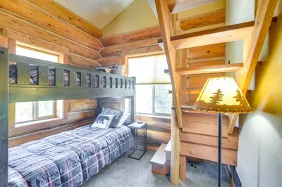 a bedroom with a bunk bed in a log cabin at Close to RMNP and Beach Grand Lake Cabin Retreat! in Grand Lake