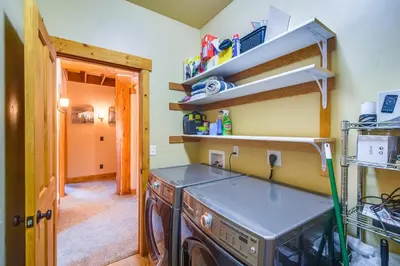 a kitchen with a washing machine in a room at Close to RMNP and Beach Grand Lake Cabin Retreat! in Grand Lake