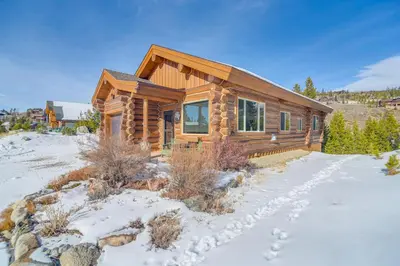 a log cabin in the snow with snow at Close to RMNP and Beach Grand Lake Cabin Retreat! in Grand Lake