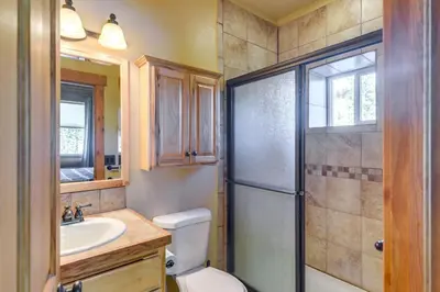 a bathroom with a shower and a toilet and a sink at Close to RMNP and Beach Grand Lake Cabin Retreat! in Grand Lake