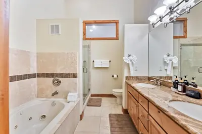 a bathroom with a tub and a sink and a toilet at Cozy 3BR Keystone Escape with Fireplace and Hot Tub in Keystone