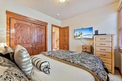 a bedroom with a large bed and a dresser at Cozy 3BR Keystone Escape with Fireplace and Hot Tub in Keystone