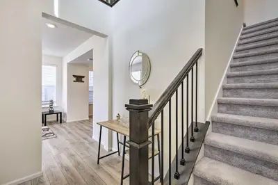 a staircase in a home with a mirror on the wall at Charming 3BR Retreat - Perfect for Families! in Fort Collins