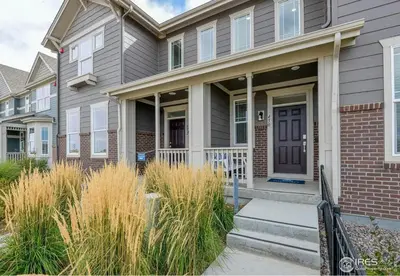 a house with a brown door and grass at Charming 3BR Retreat - Perfect for Families! in Fort Collins