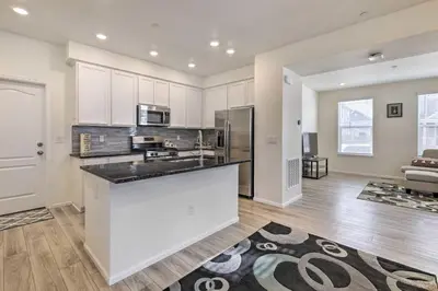 a kitchen with white cabinets and a counter top at Charming 3BR Retreat - Perfect for Families! in Fort Collins