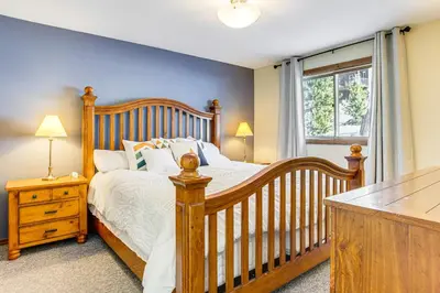 a bedroom with a crib and a window at 5 Mi to Winter Park Resort Unit with Pool and Hot Tub in Fraser