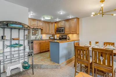 a kitchen with wooden cabinets and a counter top at 5 Mi to Winter Park Resort Unit with Pool and Hot Tub in Fraser