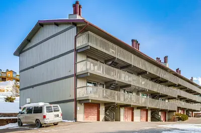 a white van parked in front of a building at 5 Mi to Winter Park Resort Unit with Pool and Hot Tub in Fraser