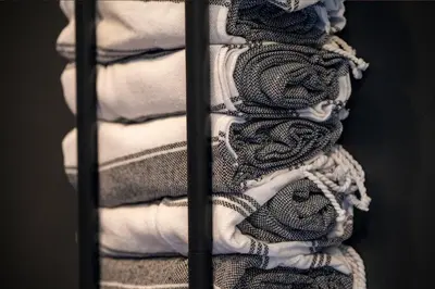 a group of towels in a towel rack at Luxurious Chalet - Epic Views, Hot Tub, Gym, Game Room, & 4k Projector in Grand Lake in Grand Lake