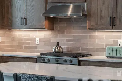 a kitchen with a stove with a kettle on it at Elevated Vibes in Fraser