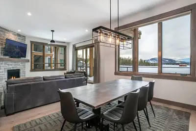 a dining room with a table and a couch at Elevated Vibes in Fraser