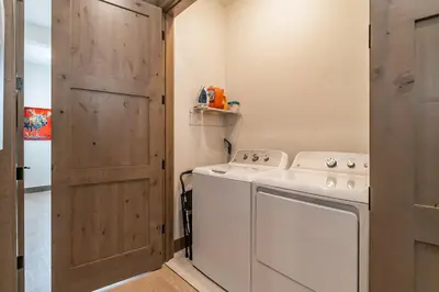 a small laundry room with a washer and dryer at Elevated Vibes in Fraser