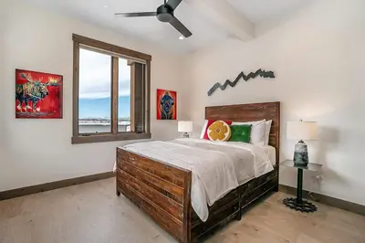 a bedroom with a large bed and a window at Elevated Vibes in Fraser