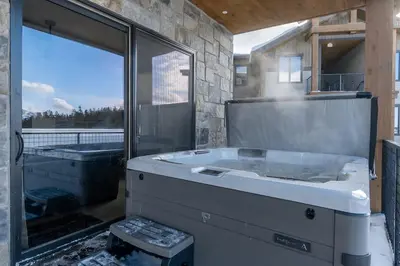 a large bath tub in a bathroom with a window at Elevated Vibes in Fraser