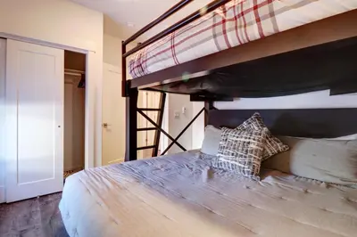 a bedroom with a bed with a bunk beduteneway at River West 611 condo in Silverthorne