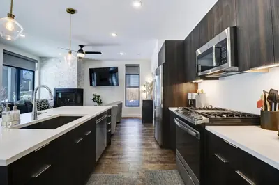 a kitchen with black cabinets and white counter tops at River West 611 condo in Silverthorne
