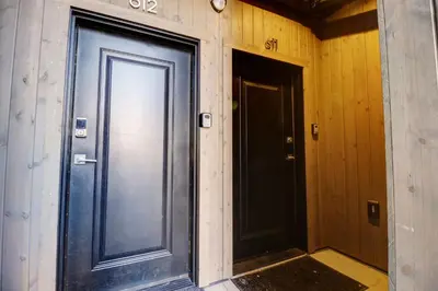 a large door in a room with two doors at River West 611 condo in Silverthorne