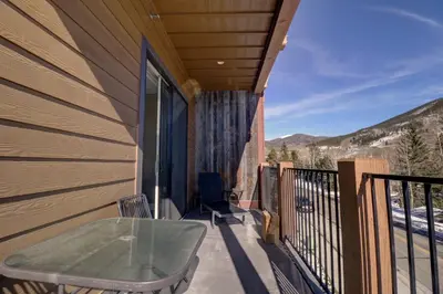 a balcony with a table and chairs on a house at Sail Lofts 205 condo in Dillon