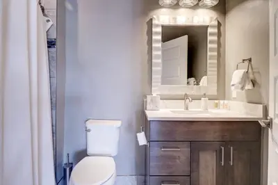 a bathroom with a toilet and a sink and a mirror at Sail Lofts 205 condo in Dillon