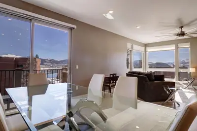 a dining room with a glass table and chairs at Sail Lofts 205 condo in Dillon