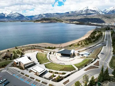 an aerial view of a lake with snow covered mountains at Sail Lofts 205 condo in Dillon