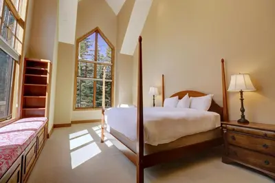 a bedroom with a bed and a large window at Peakside Escape 178 home in Silverthorne