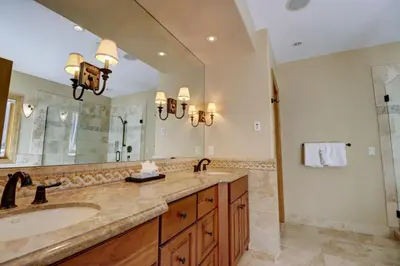 a bathroom with a sink and a large mirror at Peakside Escape 178 home in Silverthorne