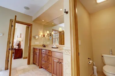 a bathroom with a sink and a toilet and a mirror at Peakside Escape 178 home in Silverthorne