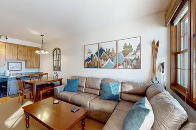 a living room with a couch and a table at Horse Lodges 5-102 in Granby