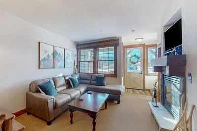 a living room with a couch and a table at Horse Lodges 5-102 in Granby