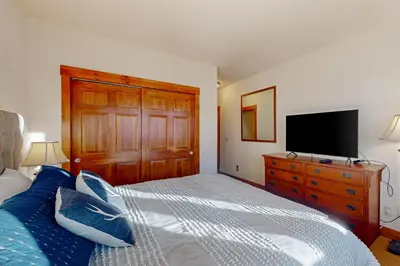 a bedroom with a bed and a tv on a dresser at Horse Lodges 5-102 in Granby