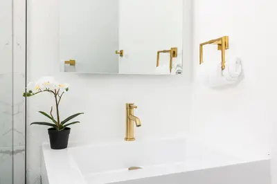a bathroom with a sink and a mirror at Lux Newly Remodeled DT, Patio, Fully Stocked 5Bd, 3Ba in Denver