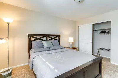 a bedroom with a large bed with blue pillows at 6 Mi to DIA Spacious Home with Backyard in Denver! in Aurora