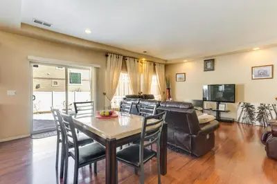 a living room with a table and chairs and a couch at 6 Mi to DIA Spacious Home with Backyard in Denver! in Aurora